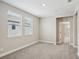 Neutral bedroom with carpeted floor and natural light from the two windows at 5093 Railroad Vine Aly, Winter Garden, FL 34787