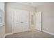 Bright bedroom showcases plush carpet, neutral walls, large window, and a closet with double doors at 5093 Railroad Vine Aly, Winter Garden, FL 34787