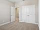 Cozy bedroom featuring plush carpet, neutral walls, and a closet with double doors at 5093 Railroad Vine Aly, Winter Garden, FL 34787
