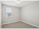 Minimalist bedroom featuring plush carpet, neutral walls, and a window allowing natural light at 5093 Railroad Vine Aly, Winter Garden, FL 34787