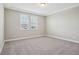 Bedroom with neutral carpet and two windows for natural light at 5093 Railroad Vine Aly, Winter Garden, FL 34787