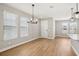 Bright dining area with hardwood floors, modern lighting, and large windows at 5093 Railroad Vine Aly, Winter Garden, FL 34787