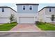 Charming two-story home featuring a two-car garage and a brick driveway in a well-maintained neighborhood at 5093 Railroad Vine Aly, Winter Garden, FL 34787