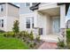 Inviting porch with stone accents and a light blue front door, framed by lush landscaping at 5093 Railroad Vine Aly, Winter Garden, FL 34787