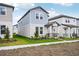 Two-story house featuring light blue siding, a covered porch, and a landscaped front yard at 5093 Railroad Vine Aly, Winter Garden, FL 34787