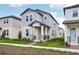 Inviting two-story home with light blue accents, complemented by a neatly landscaped front yard at 5093 Railroad Vine Aly, Winter Garden, FL 34787