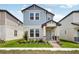 Charming two-story home with a light blue exterior and a well-manicured front yard at 5093 Railroad Vine Aly, Winter Garden, FL 34787