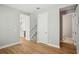 Hallway with a view to a bright kitchen, a carpeted staircase, and a nearby half bathroom at 5093 Railroad Vine Aly, Winter Garden, FL 34787