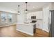 Modern kitchen featuring a central island, stainless steel appliances, and attractive pendant lighting at 5093 Railroad Vine Aly, Winter Garden, FL 34787