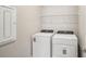 Laundry room featuring white washer and dryer, wire shelving, and a neutral color scheme at 5093 Railroad Vine Aly, Winter Garden, FL 34787