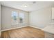 Bright living area with hardwood floors, offering ample natural light through its windows at 5093 Railroad Vine Aly, Winter Garden, FL 34787