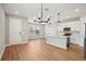 Open-concept space with wood floors, modern lighting, and a kitchen island at 5093 Railroad Vine Aly, Winter Garden, FL 34787