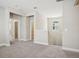Bright loft area features carpet flooring, and stairs to the second floor at 5093 Railroad Vine Aly, Winter Garden, FL 34787