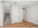 A carpeted staircase leads to the upper level of the home, alongside a hallway at 5093 Railroad Vine Aly, Winter Garden, FL 34787
