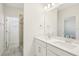 Bright bathroom featuring double sinks, white cabinets, and a glass-enclosed shower at 5099 Railroad Vine Aly, Winter Garden, FL 34787
