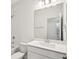 Bright bathroom featuring white walls, a shower-tub combo and a large mirror above the sink at 5099 Railroad Vine Aly, Winter Garden, FL 34787