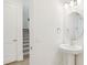 Charming half-bathroom features an oval mirror and modern lighting at 5099 Railroad Vine Aly, Winter Garden, FL 34787