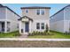 Charming two-story home with a blue front door and well-manicured lawn at 5099 Railroad Vine Aly, Winter Garden, FL 34787