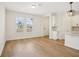 Bright and airy living space with hardwood floors, and an open layout featuring a white kitchen at 5099 Railroad Vine Aly, Winter Garden, FL 34787