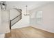 Bright, naturally lit living room with wood floors, staircase and stylish chandelier at 5099 Railroad Vine Aly, Winter Garden, FL 34787