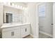 Bright bathroom featuring double vanity, modern lights, and walk-in toilet room at 5106 Railroad Vine Aly, Winter Garden, FL 34787