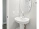 Bathroom featuring vanity with round mirror and pedestal sink at 5106 Railroad Vine Aly, Winter Garden, FL 34787
