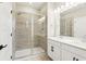 Modern bathroom with a glass shower, dual sinks, and neutral tile at 5106 Railroad Vine Aly, Winter Garden, FL 34787