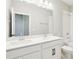 Bright bathroom featuring double vanity, large mirror, and shower with tub at 5106 Railroad Vine Aly, Winter Garden, FL 34787