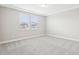 Spacious bedroom with neutral carpet, tray ceiling, and two bright windows at 5106 Railroad Vine Aly, Winter Garden, FL 34787