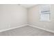 Simple bedroom with neutral carpet, light gray walls and a single window at 5106 Railroad Vine Aly, Winter Garden, FL 34787