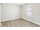 Bedroom with wood-look flooring and window with view at 5106 Railroad Vine Aly, Winter Garden, FL 34787