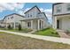 Well-manicured lawn and landscaping lead up to a charming two-story home with a welcoming front porch at 5106 Railroad Vine Aly, Winter Garden, FL 34787