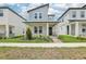 Charming two-story home featuring a quaint front porch, modern architectural details, and neatly manicured landscaping at 5106 Railroad Vine Aly, Winter Garden, FL 34787