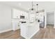 The kitchen features stainless steel appliances, white cabinets, and a large island at 5106 Railroad Vine Aly, Winter Garden, FL 34787