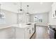 A bright kitchen with modern appliances, a large center island, and an open layout at 5106 Railroad Vine Aly, Winter Garden, FL 34787