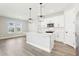 Modern kitchen with white cabinets, stainless appliances, and a large center island at 5106 Railroad Vine Aly, Winter Garden, FL 34787