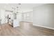 Open concept floor plan features a stylish kitchen with a white island and stainless steel appliances at 5106 Railroad Vine Aly, Winter Garden, FL 34787