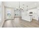 Bright open-concept kitchen features stainless appliances, island, and pendant lighting at 5106 Railroad Vine Aly, Winter Garden, FL 34787