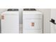 New, white laundry appliances located in a clean and bright space at 5106 Railroad Vine Aly, Winter Garden, FL 34787