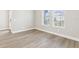 Bright living room showcasing new wood flooring, base trim and abundant natural light from the large windows at 5106 Railroad Vine Aly, Winter Garden, FL 34787