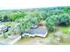 Aerial view of the house showcasing mature trees, a newer roof and well-maintained surroundings at 5390 E Hinson Ave, Haines City, FL 33844