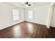 This bedroom features hardwood floors and natural light from the new windows at 5390 E Hinson Ave, Haines City, FL 33844