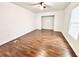 This bedroom features hardwood floors and natural light from the new windows at 5390 E Hinson Ave, Haines City, FL 33844