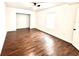 Cozy bedroom with dark hardwood floors, a ceiling fan, and a walk in closet at 5390 E Hinson Ave, Haines City, FL 33844