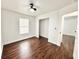 Bright bedroom featuring wood floors, a ceiling fan, natural light, and a closet at 5390 E Hinson Ave, Haines City, FL 33844