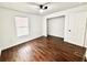 This bedroom features wood floors and natural light from the new windows and a closet at 5390 E Hinson Ave, Haines City, FL 33844