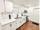 Modern kitchen featuring white cabinets, stainless steel appliances, and sleek countertops at 5390 E Hinson Ave, Haines City, FL 33844