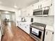 Modern kitchen featuring white cabinets, stainless steel appliances, and sleek countertops at 5390 E Hinson Ave, Haines City, FL 33844