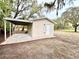 Charming outbuilding with a covered area and ample storage in a serene yard at 5390 E Hinson Ave, Haines City, FL 33844