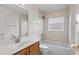 Bright bathroom with a tiled shower/tub and a vanity with a marble countertop at 5580 Berwood Dr, Orlando, FL 32810